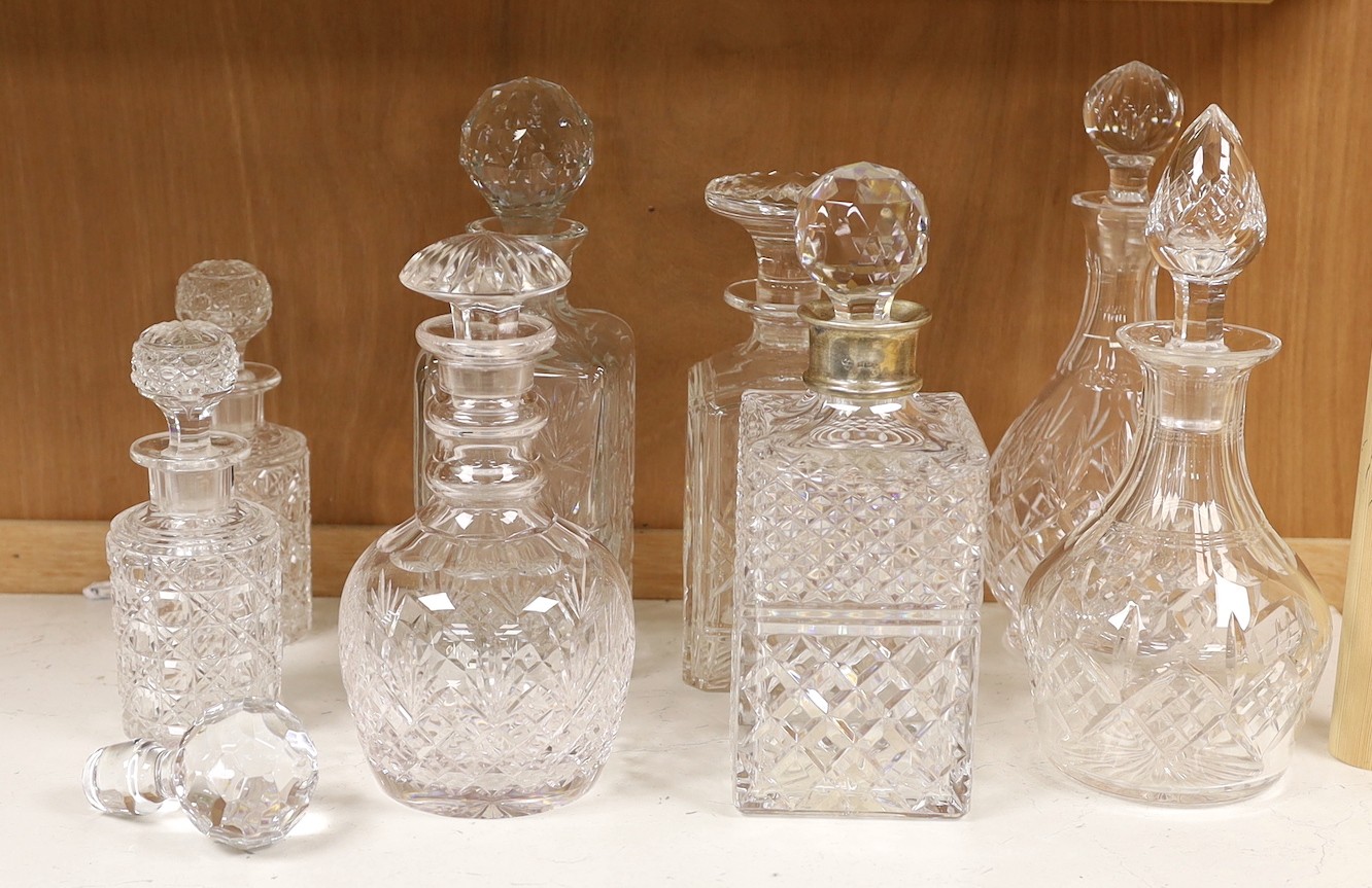 A silver mounted decanter, four others and a smaller pair of decanters, tallest 27.5cm